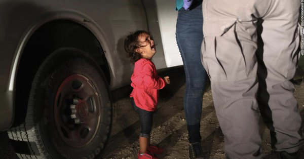 a widely-seen photo of a small girl crying in front of a cop